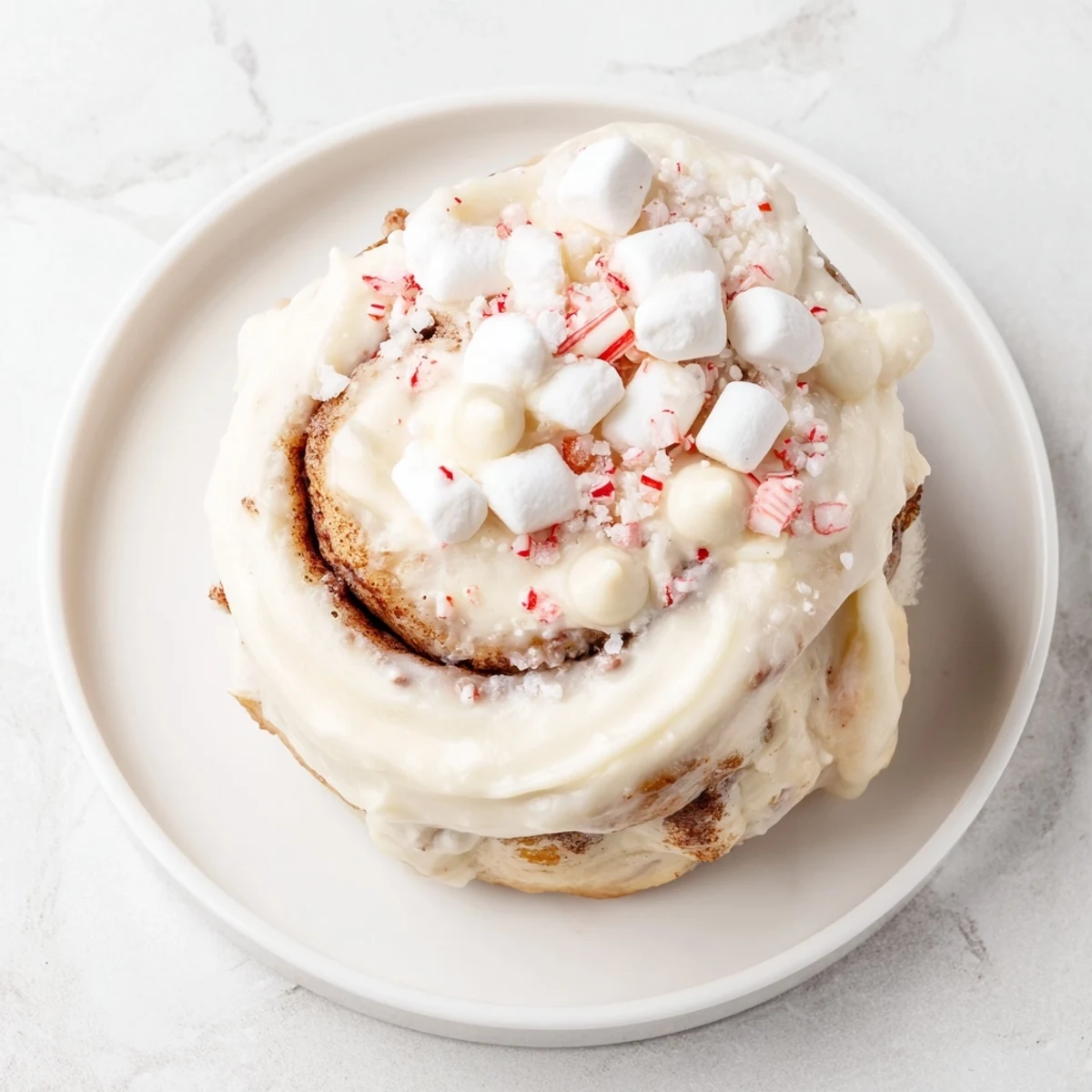 A festive North Pole Cinnamon Roll Board piled high with frosted, warm cinnamon rolls.