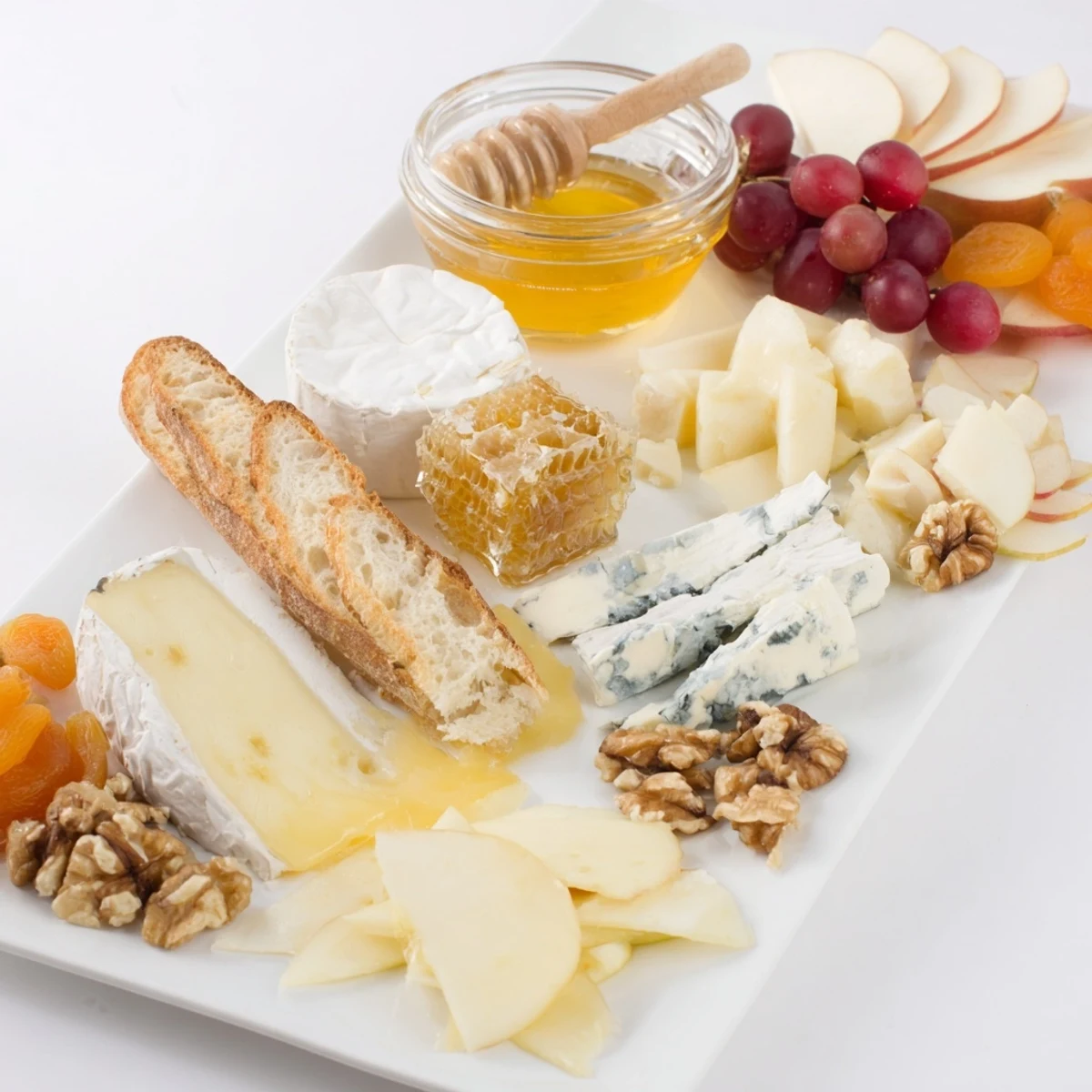 An inviting honeycomb, honey & cheese board overflowing with creamy Brie and delicious accompaniments.