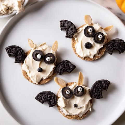 Festive Flying Bat Halloween Snack Board, featuring sweet and savory bat treats with colorful veggies.