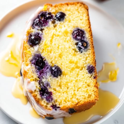 Freshly baked Lemon Blueberry Yogurt Loaf, steaming gently, perfect for a cozy morning treat.