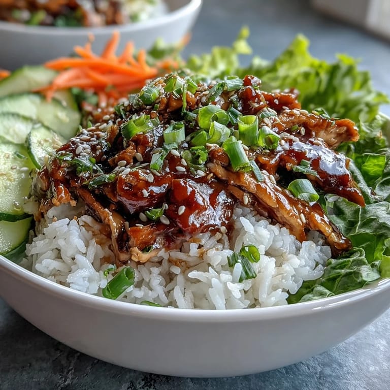 Family-style Korean sesame turkey lettuce wrap bowls ready to scoop, garnished with sesame seeds and herbs.